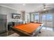 Bright game room with pool table, bar area, and direct access to an ocean view balcony at 1907 S Waccamaw Dr., Garden City Beach, SC 29576