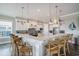Bright kitchen features an island with a marble countertop, pendant lighting, and stainless steel appliances at 1907 S Waccamaw Dr., Garden City Beach, SC 29576