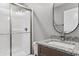 Modern bathroom with granite countertop, oval mirror, and glass shower at 2260 Pearl Rd., Galivants Ferry, SC 29544