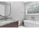 Bathroom with freestanding bathtub and oval mirror at 2260 Pearl Rd., Galivants Ferry, SC 29544