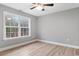 Bright bedroom with wood-look floors, large window, and ceiling fan at 2260 Pearl Rd., Galivants Ferry, SC 29544