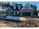 New construction home with stone and shingle exterior, two-car garage, and large windows at 2260 Pearl Rd., Galivants Ferry, SC 29544