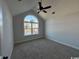 Spacious bedroom with large arched window and ceiling fan at 2264 Pearl Rd., Galivants Ferry, SC 29544