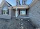 Front view of a house with gray brick, columns, and a covered porch at 2264 Pearl Rd., Galivants Ferry, SC 29544