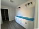 Bright laundry room with white cabinets and vinyl flooring at 2264 Pearl Rd., Galivants Ferry, SC 29544