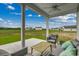 Covered patio with outdoor furniture overlooking a green field at 313 Mayflower Dr., Calabash, NC 28467