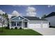 New construction home featuring a two-car garage and modern siding at 364 Mayflower Dr., Calabash, NC 28467