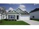 Craftsman style home, green siding, white garage door, and manicured lawn at 714 Night Lotus Dr., Calabash, NC 28467