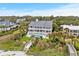 Aerial view of luxurious three-story home with a pool, manicured lawn and beach access at 8000 Beach Dr., Myrtle Beach, SC 29572