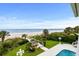 Lush backyard leading to a sandy beach, featuring a cabana and manicured lawn at 8000 Beach Dr., Myrtle Beach, SC 29572