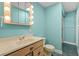 Small bathroom with light teal walls and wood vanity at 8000 Beach Dr., Myrtle Beach, SC 29572