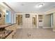 Primary bathroom with dual vanities, cabinets, and tile floors at 8000 Beach Dr., Myrtle Beach, SC 29572