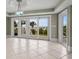 Bright living room with ocean view featuring tile floors and multiple sliding glass doors at 8000 Beach Dr., Myrtle Beach, SC 29572