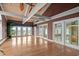 Bright living room features wood floors, beamed ceilings, doors leading to the outside and beautiful ocean views at 8000 Beach Dr., Myrtle Beach, SC 29572
