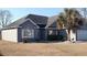 A single-Gathering home with vinyl siding and a well-maintained front lawn at 1573 Southwood Dr., Surfside Beach, SC 29575