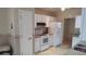 Bright kitchen featuring white appliances, cabinetry, and seashell patterned wallpaper at 1573 Southwood Dr., Surfside Beach, SC 29575