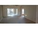 A sunlit living room featuring sliding glass doors and neutral carpeting at 1573 Southwood Dr., Surfside Beach, SC 29575