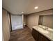 Bathroom featuring a combination tub and shower, toilet, vanity with sink and mirror, and vinyl floors at 2500 Newton Rd., Aynor, SC 29511