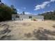 Newly constructed single story home with gray siding and stairs to the front entrance in a wooded area at 2500 Newton Rd., Aynor, SC 29511