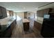 Kitchen area with island, stainless steel appliances, granite countertops, and dark wood cabinets at 2500 Newton Rd., Aynor, SC 29511