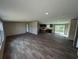 Open living room and kitchen with vinyl floors, recessed lighting, and sliding glass doors to the deck at 2500 Newton Rd., Aynor, SC 29511