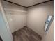 Empty walk-in closet with built in shelves and vinyl flooring at 2500 Newton Rd., Aynor, SC 29511