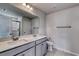 Double vanity bathroom with gray cabinets and a large mirror at 607 Mccorkle Place, Conway, SC 29526