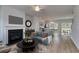 Living room with fireplace and view into the open concept kitchen at 607 Mccorkle Place, Conway, SC 29526