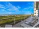 Relaxing balcony with lounge chairs overlooking the ocean and coastline at 1237 Clipper Rd., North Myrtle Beach, SC 29582
