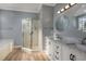 Bright bathroom featuring double sinks, granite countertops, and a glass-enclosed shower at 1237 Clipper Rd., North Myrtle Beach, SC 29582