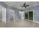 Spacious room with tile floors, ceiling fan, access to laundry room, and storage with shelving at 1237 Clipper Rd., North Myrtle Beach, SC 29582