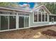 Rear exterior showing sliding glass doors and a screened porch at 1237 Clipper Rd., North Myrtle Beach, SC 29582