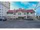 Exterior of beach house on stilts with a red roof and parking at 1237 Clipper Rd., North Myrtle Beach, SC 29582