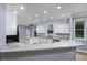 Bright kitchen features granite counters, white cabinetry, stainless appliances and eat-at bar at 1237 Clipper Rd., North Myrtle Beach, SC 29582