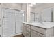 Modern bathroom featuring double sinks, vanity, and a glass-enclosed shower with tile surround at 3038 Deerberry Place, Longs, SC 29568