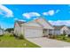 Single story home with a white garage door, neutral siding, and well-maintained front lawn at 3038 Deerberry Place, Longs, SC 29568