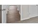 The hallway boasts hardwood floors and white doors leading to various rooms at 3038 Deerberry Place, Longs, SC 29568