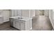 Bright, airy kitchen with an island, stainless steel dishwasher, and contemporary finishes at 3038 Deerberry Place, Longs, SC 29568