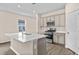 Well-lit kitchen boasts stainless appliances, an island, and ample cabinet space at 3038 Deerberry Place, Longs, SC 29568