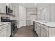 Well-appointed kitchen featuring stainless steel appliances, a large island, and stylish cabinetry at 3038 Deerberry Place, Longs, SC 29568