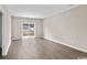 Bright living room with hardwood floors and sliding glass doors leading to the backyard at 3038 Deerberry Place, Longs, SC 29568