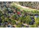 Aerial view of home featuring mature trees, a golf course in the distance, and lush greenery at 4569 Carriage Run Circle, Murrells Inlet, SC 29576