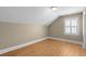 This spacious bedroom features wood floors and a window at 4569 Carriage Run Circle, Murrells Inlet, SC 29576