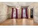 Elegant dining room boasting hardwood floors, crown molding, and a stylish chandelier for sophisticated dining at 4569 Carriage Run Circle, Murrells Inlet, SC 29576