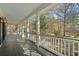 Expansive covered porch, with classic white columns, offers a peaceful view of the surrounding landscape at 4569 Carriage Run Circle, Murrells Inlet, SC 29576