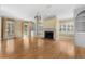 Sunlit living room featuring a cozy fireplace, built-in shelving, and ample windows with plantation shutters at 4569 Carriage Run Circle, Murrells Inlet, SC 29576