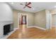 Spacious living room with hardwood floors, white-painted fireplace, and doorway to dining room at 4569 Carriage Run Circle, Murrells Inlet, SC 29576