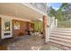 Relaxing covered brick patio features a BBQ grill, brick columns and outdoor staircase at 4569 Carriage Run Circle, Murrells Inlet, SC 29576