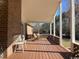 Covered back porch with brick siding, wood flooring, outdoor furniture, and a view of the backyard at 5864 Crestwood Dr., Myrtle Beach, SC 29578