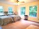 Bright bedroom with a ceiling fan, two beds, and large windows providing natural light at 5864 Crestwood Dr., Myrtle Beach, SC 29578